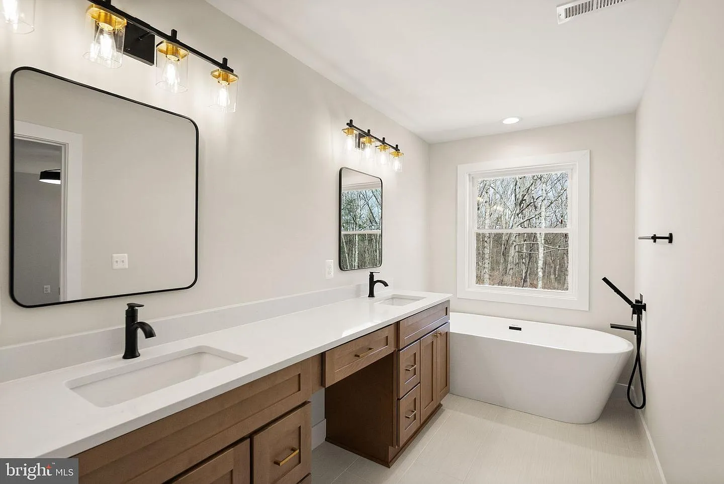 Bathroom with freestanding tub and wood vanity