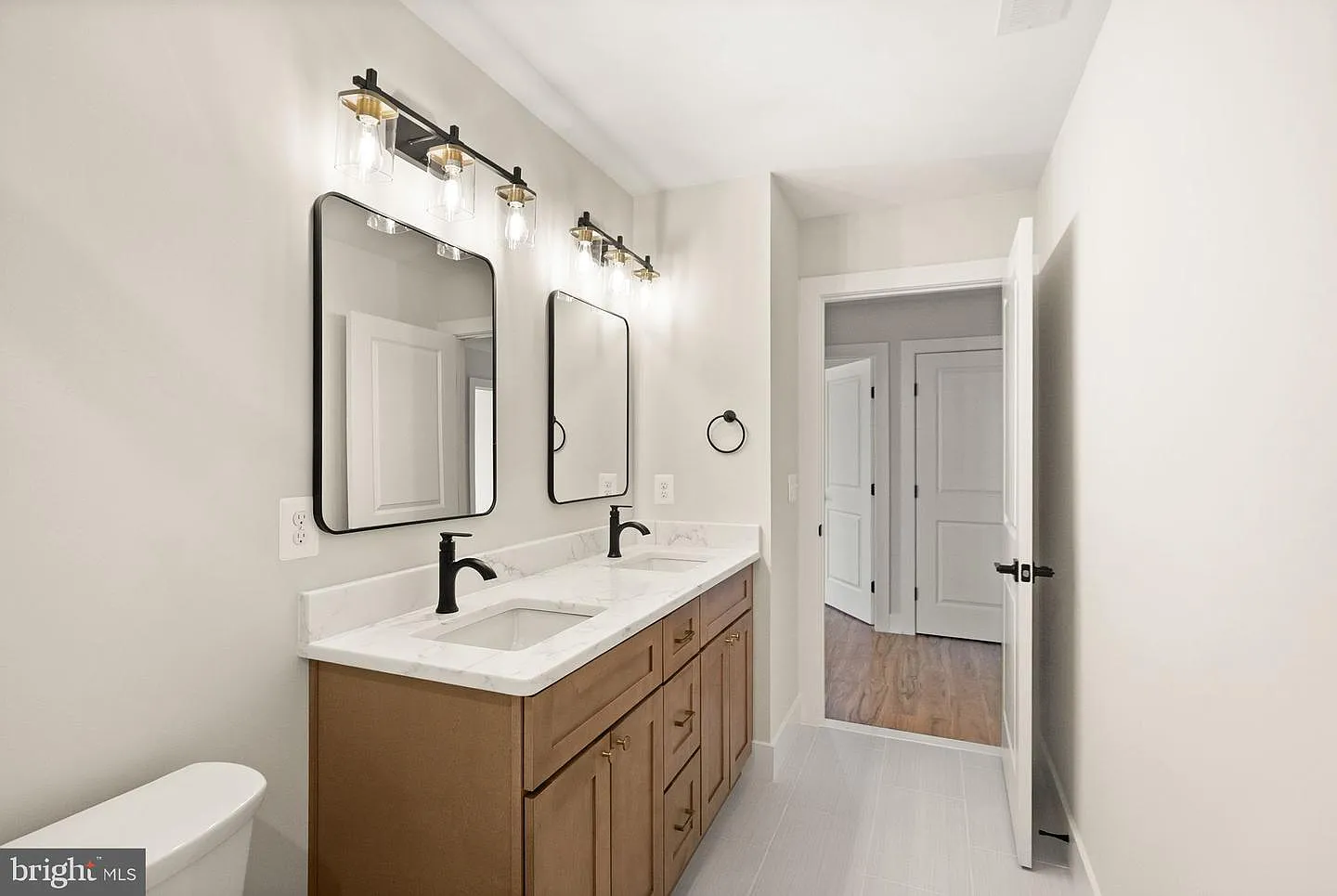 Wood vanity bathroom with hallway connection