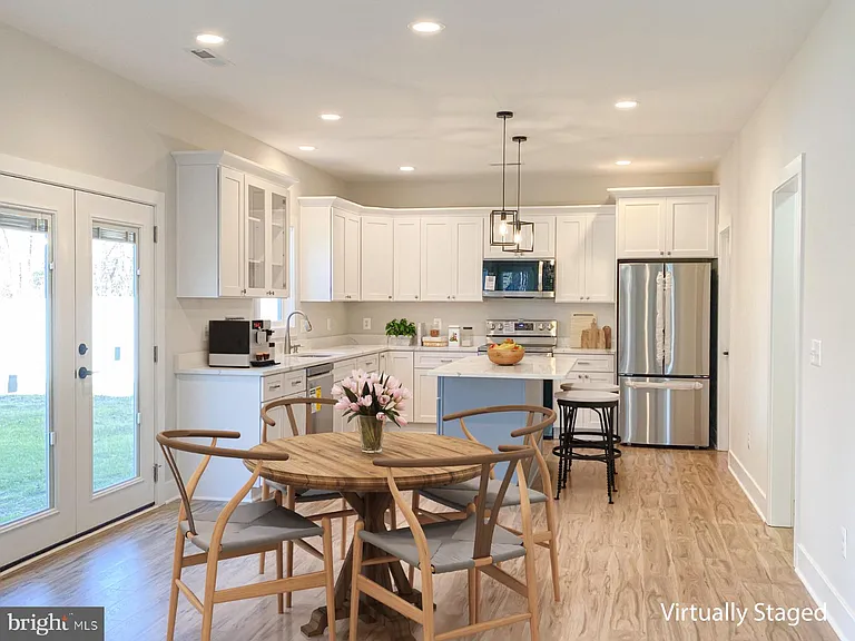 Kitchen and dining area with white cabinetry