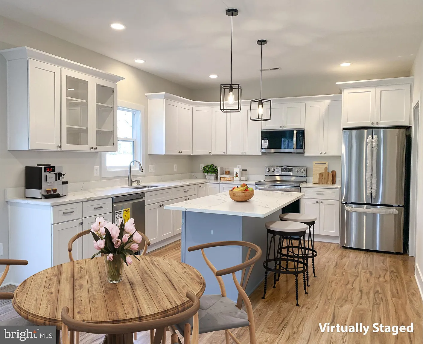 Staged kitchen with dining table and island seating