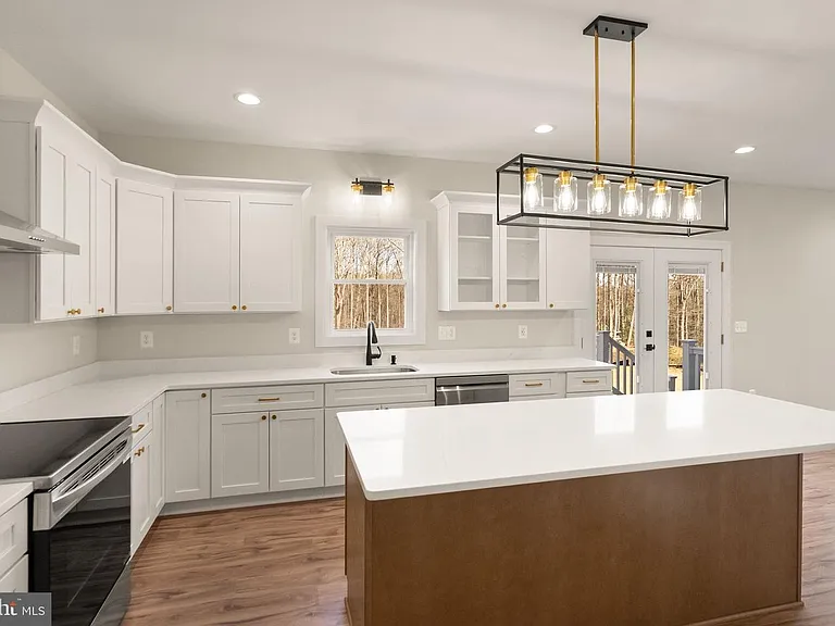 White kitchen cabinetry with island and rear entry